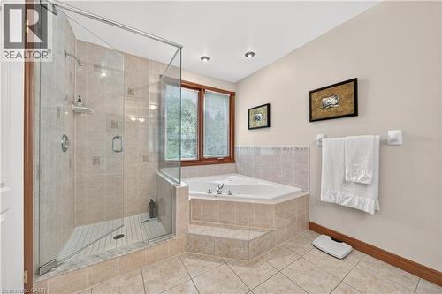 Walk-in glass-enclosed shower with tile surround, corner-set soaking tub, and tile flooring - 52 Archwood Crescent, Cambridge, ON 