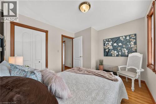 Hardwood flooring, painted walls, white trim, and a flush mount ceiling fixture - 52 Archwood Crescent, Cambridge, ON 