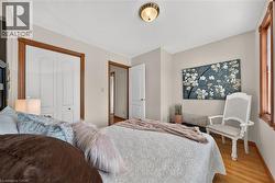 Hardwood flooring, painted walls, white trim, and a flush mount ceiling fixture - 