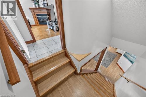 Wood-finish flooring throughout, featuring a natural wood staircase with matching handrails - 52 Archwood Crescent, Cambridge, ON 