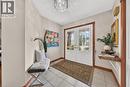 Double entry doors with decorative glass panels, tile flooring, and wood trim accents - 52 Archwood Crescent, Cambridge, ON 
