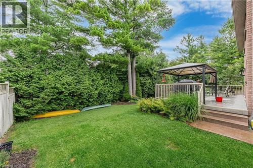 Expansive grassy yard with mature trees and perimeter hedges - 52 Archwood Crescent, Cambridge, ON 
