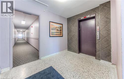 Corridor with elevator, tile walls, and an accent wall - 283 Fairway Road N Unit# 501, Kitchener, ON 