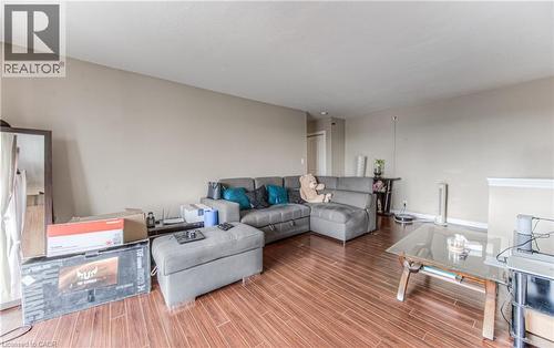 Living area featuring wood finished floors and baseboards - 283 Fairway Road N Unit# 501, Kitchener, ON 