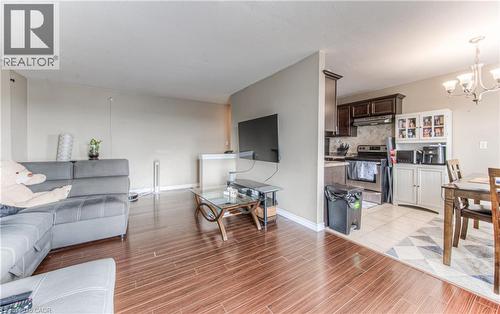 Living area with a chandelier and wood tiled floors - 283 Fairway Road N Unit# 501, Kitchener, ON 