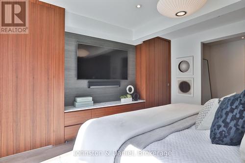Wall of custom built-ins, concealed walk-in closet - 69 Sullivan Street, Toronto, ON 