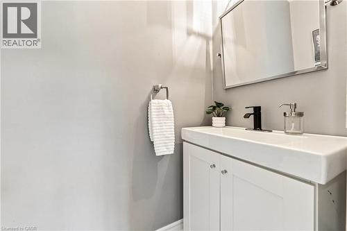 White vanity with integrated sink, matte black faucet, framed mirror, and chrome towel ring - 1270 Gainsborough Drive Unit# 61, Oakville, ON 