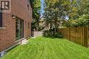 Red brick exterior with sliding glass door and exterior lighting fixtures - 279 Hess Street S, Hamilton, ON 