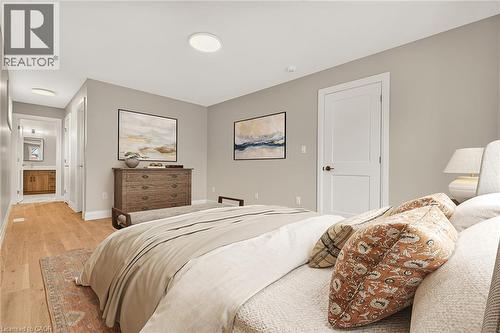 Recessed ceiling lighting, wood-finish flooring, light-toned walls, and a white two-panel door - 279 Hess Street S, Hamilton, ON 