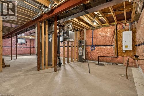 Unfinished lower level with concrete flooring, exposed wood joists, and structural steel beams - 279 Hess Street S, Hamilton, ON 