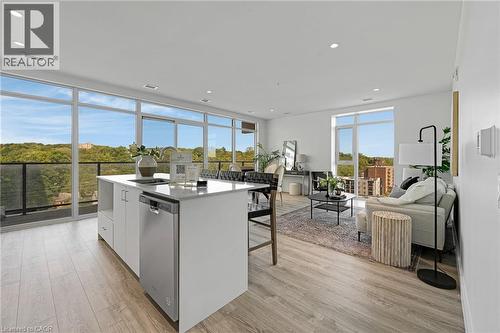Kitchen with white cabinets, dishwasher, an island with sink, light wood-style flooring, and recessed lighting - 50 Grand Avenue S Unit# 801, Cambridge, ON 