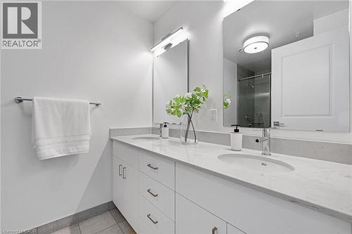 Bathroom featuring a shower stall, double vanity, and light tile patterned flooring - 50 Grand Avenue S Unit# 801, Cambridge, ON 