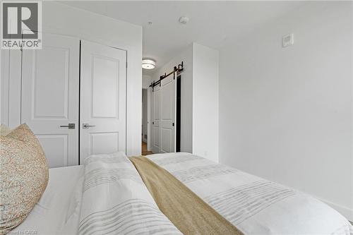 Bedroom featuring a barn door and a closet - 50 Grand Avenue S Unit# 801, Cambridge, ON 