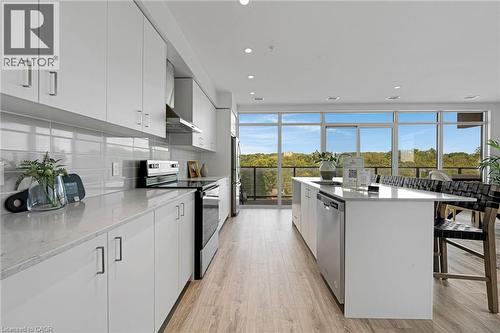 Kitchen featuring white cabinetry, stainless steel appliances, light stone countertops, and recessed lighting - 50 Grand Avenue S Unit# 801, Cambridge, ON 