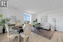 Dining room with light wood-style floors and recessed lighting - 