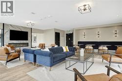 Living room featuring light wood-style floors and a fireplace - 