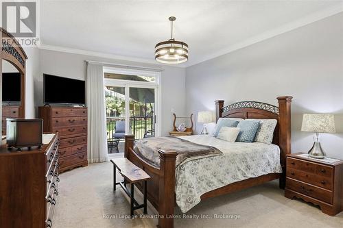 Primary bedroom with sliding doors to deck. - 10G - 25 Rivermill Boulevard, Kawartha Lakes (Lindsay), ON 
