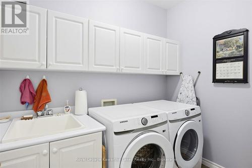Laundry room with laundry sink and cupboards. - 10G - 25 Rivermill Boulevard, Kawartha Lakes (Lindsay), ON 