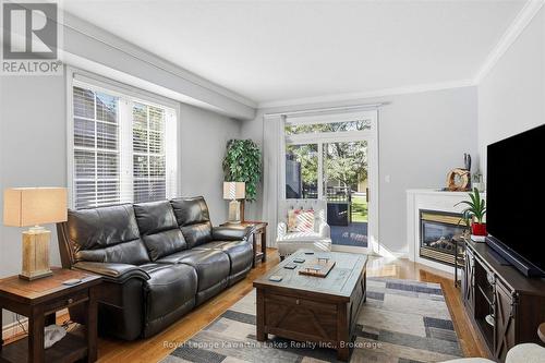 Living room with sliding doors to composite deck. - 10G - 25 Rivermill Boulevard, Kawartha Lakes (Lindsay), ON 