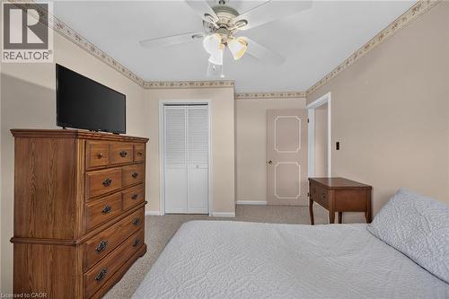 Ceiling fan with integrated lighting, textured wall trim, and a white bi-fold closet door - 799 Highway 6, Caledonia, ON 