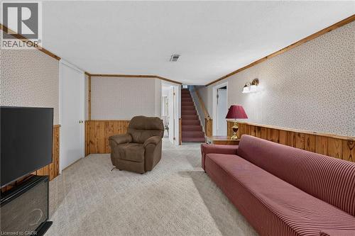 Carpeted room with a wallpapered finish, wood paneling, and wood trim - 799 Highway 6, Caledonia, ON 