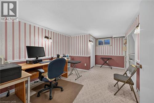 Wall-mounted sconce lighting, carpeted flooring, built-in shelving, and a single window - 799 Highway 6, Caledonia, ON 