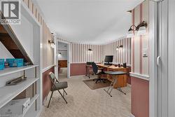 Carpeted flooring throughout, accented by wall-mounted lighting fixtures - 