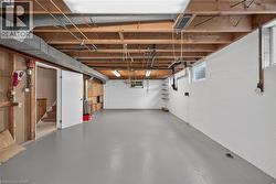 Finished concrete flooring, exposed ceiling joists, white painted block walls, and built-in shelving - 