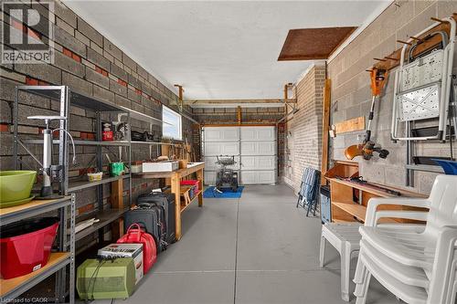 Interior block wall construction, concrete flooring, overhead garage door, and built-in shelving - 799 Highway 6, Caledonia, ON 