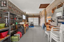 Interior block wall construction, concrete flooring, overhead garage door, and built-in shelving - 
