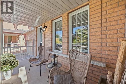 Covered front porch with brick exterior, white railing, and white window trim - 2409 Postmaster Drive, Oakville, ON 