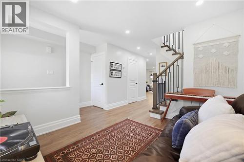 Recessed lighting, wood-finish flooring, white trim, and a staircase with metal balusters - 2409 Postmaster Drive, Oakville, ON 