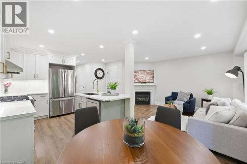 Recessed lighting illuminates the open-concept living space with wood-finish flooring - 2409 Postmaster Drive, Oakville, ON 
