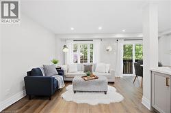 Wood-finish flooring, recessed lighting, and white crown molding - 