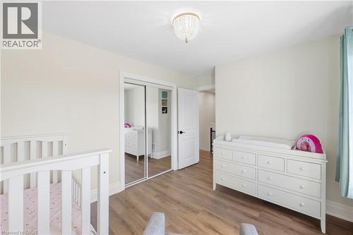 Recessed lighting, wood-finish flooring, white trim, and a frosted glass chandelier - 2409 Postmaster Drive, Oakville, ON 
