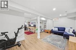 Recessed ceiling lighting, wood-finish flooring, and white painted walls - 
