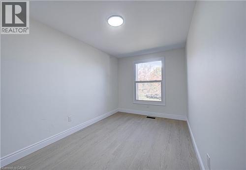 Recessed ceiling light fixture, wood-finish flooring, and a double-hung window - 210 Ferguson Avenue, Cambridge, ON 