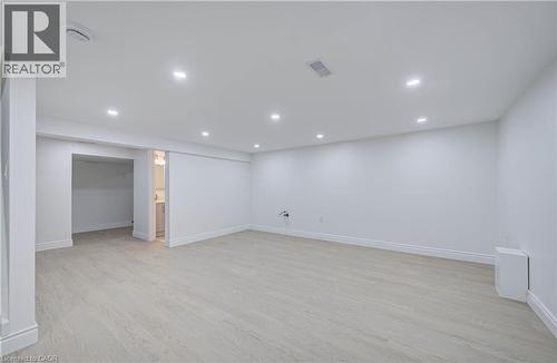 Recessed lighting illuminating the expansive room, light wood-finish flooring, and white wall finishes - 210 Ferguson Avenue, Cambridge, ON 