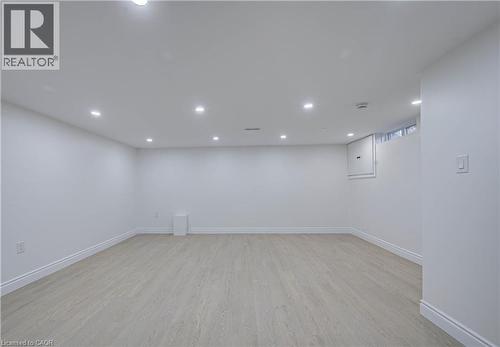 Recessed ceiling lighting, light wood-finish flooring, white wall paint, and a window - 210 Ferguson Avenue, Cambridge, ON 