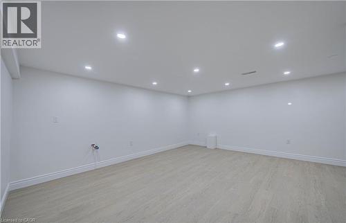 Recessed ceiling lighting, light wood-finish flooring, white walls, and a white baseboard trim - 210 Ferguson Avenue, Cambridge, ON 