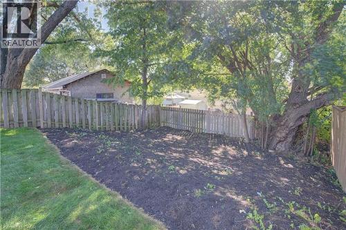 Grassy lawn with a fenced perimeter and mature trees - 210 Ferguson Avenue, Cambridge, ON 