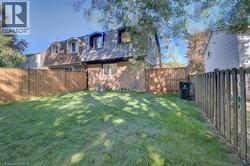 Expansive grassy yard with wood fencing and a gate - 