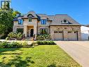 Stone and stucco facade featuring a prominent portico and multiple dormer windows - 236 Poplar Drive, Burlington, ON 
