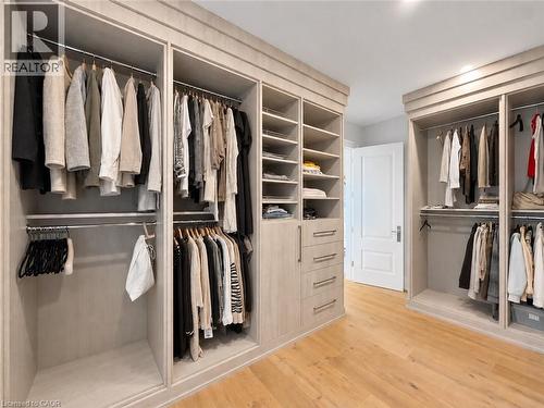 Built-in wardrobe system with multiple hanging rods, integrated shelving, and drawer storage - 236 Poplar Drive, Burlington, ON 