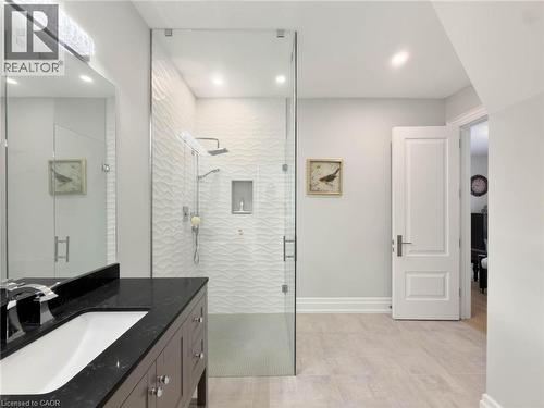 Glass-enclosed shower with textured tile surround and recessed niche - 236 Poplar Drive, Burlington, ON 