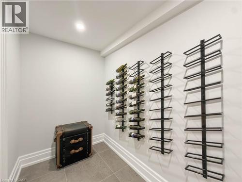 Recessed ceiling lighting, wall-mounted wine storage racks, tile flooring, and layered base molding - 236 Poplar Drive, Burlington, ON 