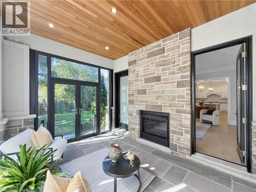 Sunroom with a wood-finish plank ceiling and recessed lighting - 236 Poplar Drive, Burlington, ON 