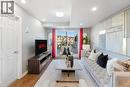 Living area featuring light gray walls, wood-finish flooring, recessed lighting, and a sliding glass door - 1380 Costigan Road Unit# 13, Milton, ON 
