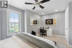 Bedroom featuring neutral-toned walls, recessed lighting, and a ceiling fan - 