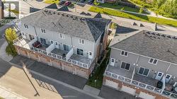 Two-story townhome residences featuring individual garage access and private elevated patios - 